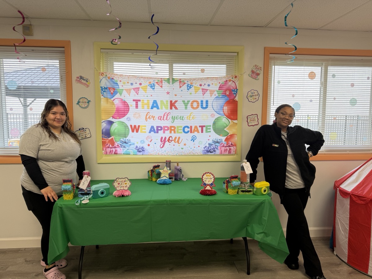 Two educators posing at the appreciation table